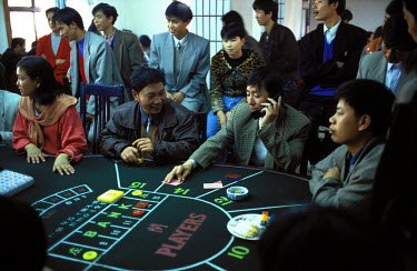 Chinese gambling at a casino in the free zone between border posts at the Jiegao border settlement on the Burma side of Ruili River. Gambling is illegal in China. The border is booming with trade both...