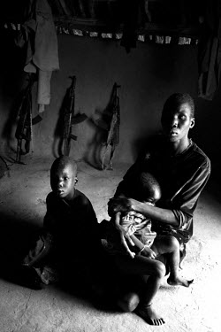 Mother and children in the church in Tam, where the SPLA (Sudan People's Liberation Army) keeps its weapons. The church serves as a hospital for wounded soldiers and other local people that have staye...