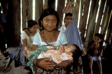 Quequchi Mayan girl holding her baby sister.