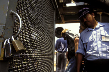 Security guard at an official diamond mine, operated on behalf of the government by a Brazilian company called Oderbrecht. The area where the diamonds are sorted is under constant armed guard.Angola...