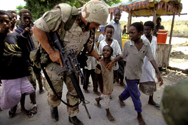 American Marines on patrol in Mogadishu during 'Operation Restore Hope' being mobbed by local children.In 1991 President Barre was overthrown by opposing clans,  but they failed to agree on a replace...