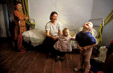 Nadia Zagozina and her daughters Zina, 4 and Luba, 18 months, both of whom suffer from problems with the central nervous system. They live in the village of Mostic, north of the epicentre of the explo...