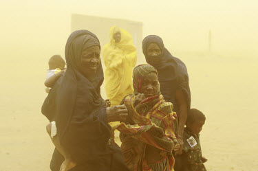Black Moors, the former and current slaves, shelter from a sandstorm. Although Mauritania officially abolished slavery in 1981, there is considerable discrimination against former slaves and human rig...