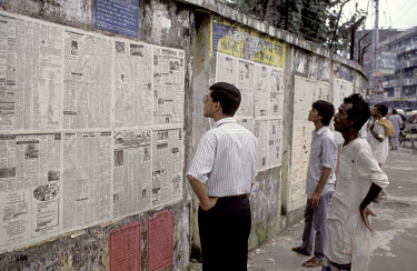 Daily newspaper posted to a wall for members of the public to read.