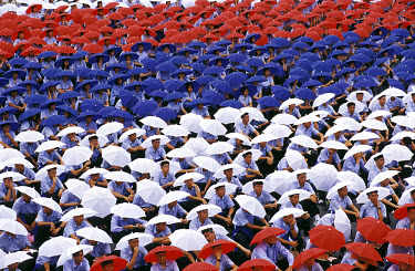 Sea of students wearing umbrella hats in the national colours during Taiwan's National Day celebrations.