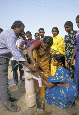Local worker from the British NGO Wateraid trains village women to maintain and repair their own water pumps.
