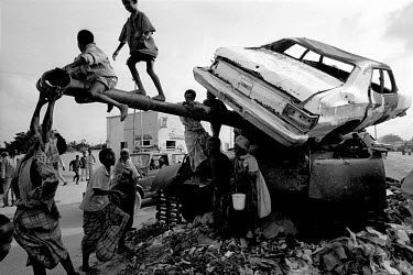 Children playing on an abandoned tank. In 1991 President Barre was overthrown by opposing clans, but they failed to agree on a replacement and plunged the country into lawlessness and clan warfare. In...