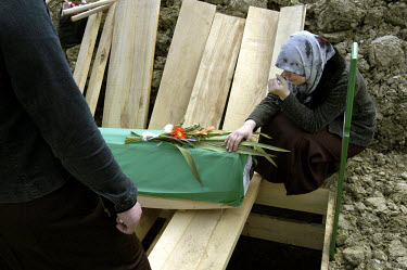 A woman mourns over the coffin of one of the many thousands of victims of the 1995 Srebrenica massacre. Eight years on, the first funerals took place. 600 bodies were buried at Potocari, opposite the...