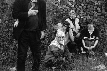 Survivors of the Huric family watch as the bodies of their menfolk, Zuhdija (28), Bego (40) and Camil (63) are exhumed. They were shot on their doorsteps by Serbs from the next village at the beginnin...