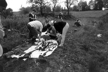 Survivors of the Huric family watch as the bodies of their menfolk, Zuhdija (28), Bego (40) and Camil (63) are exhumed. They were shot on their doorsteps by Serbs from the next village at the beginnin...