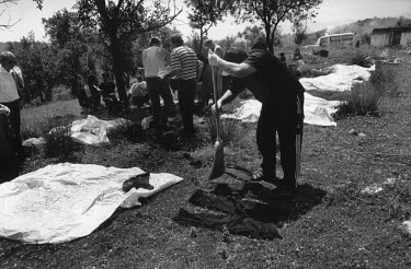 A worker with the Commission for Missing Persons cleans clothing exhumed from a grave in order to help identify the body. Up to seven thousand men and boys were massacred by the Serb forces after the...