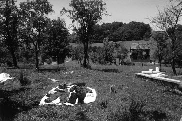 Clothes from a victim of ethnic cleansing are laid out in the sun to dry before being examined for clues as to the identity of the victim. This village was ethnically cleansed in 1992, most of the men...