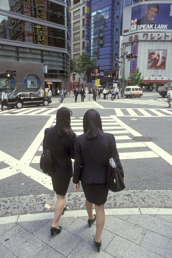 Office workers crossing the street in the Shinjuku district.