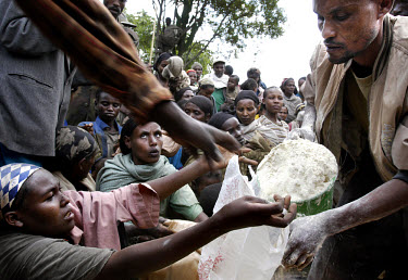 An employee of a local NGO distributes food to a waiting crowd. The severe drought in the south of the country has compounded problems caused by insufficient foreign aid. Around 13 million Ethiopians...