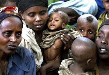 Women with malnourished children, amongst a crowd waiting for food distribution. The severe drought in the south of the country has compounded problems caused by insufficient foreign aid. Around 13 mi...