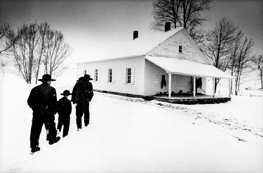 A snowy Sunday, the day of prayer for the Amish community. Families come to church by horse and carriage. After putting out the horses, they complete the last part of the journey on foot, the women an...