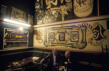 Two men enjoy a quiet pint in Annie Miller's, a pub decorated with Rangers memorabilia.The 'Old Firm' rivalry between Celtic and Rangers is renowned as the world's most intense football derby.