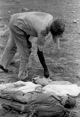 A worker buries dead children, some of thousands who died during the 1992 famine caused by the civil war in Somalia. In 1991 President Barre was overthrown by opposing clans, but they failed to agree...