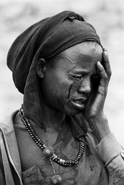 A woman cries after being beaten by an armed gang during the 1992 famine caused by the civil war in Somalia. In 1991 President Barre was overthrown by opposing clans, but they failed to agree on a rep...
