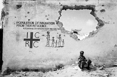 A woman waits outside a Red Cross (ICRC) feeding centre, during the 1992 famine caused by the civil war in Somalia. In 1991 President Barre was overthrown by opposing clans, but they failed to agree o...