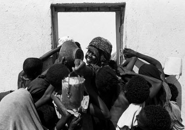 Refugees scramble for food outside a feeding centre during the 1992 famine caused by the civil war in Somalia. In 1991 President Barre was overthrown by opposing clans, but they failed to agree on a r...