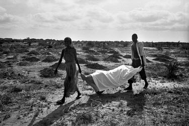 A family bury their relative, one of thousands who died during the 1992 famine caused by the civil war in Somalia. In 1991 President Barre was overthrown by opposing clans, but they failed to agree o...