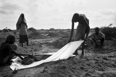 A family bury their relative, one of thousands who died during the 1992 famine caused by the civil war in Somalia. In 1991 President Barre was overthrown by opposing clans, but they failed to agree on...