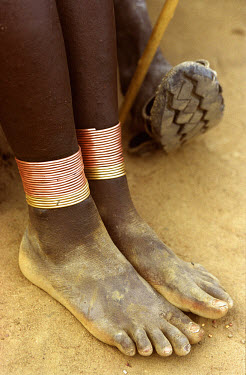 Ankle bracelets and shoes made from car tyres.The Karamojong are a cattle-herding, pastoralist people who live in semi-permanent settlements.