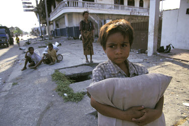 Children scavenging on the streets and in destroyed buildings looking for food.