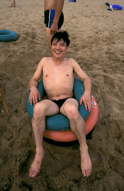 A happy holidaymaker relaxes on a favourite beach of the new urban middle class from Beijing and Tianjin. The resort of Beidaihe has been favoured by the elite of the Communist Party from Mao onwards.