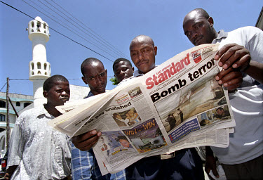 The day after the terrorist attacks in Mombasa, locals read newspaper reports outside a mosque after Friday prayers. 13 people were killed when a car bomb exploded outside the Israeli-owned Paradise H...
