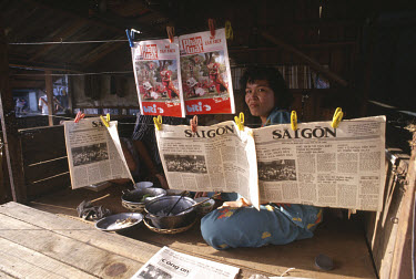 Woman selling 'Saigon' newspapers.