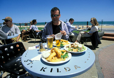 A lunch of lager, fish and chips on St Kilda beach.