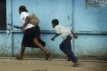 Civilians running for cover on UN Drive. Stray bullets are part of daily life in Monrovia. On some streets and intersections you just have to run. ~The ongoing conflict in Liberia intensified in March...