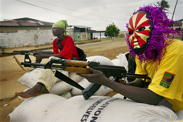 Carnival chic at a government checkpoint on Mamba Point.~The ongoing conflict in Liberia intensified in March 2003 when rebels opposed to the government of Charles Taylor gained territory across much...