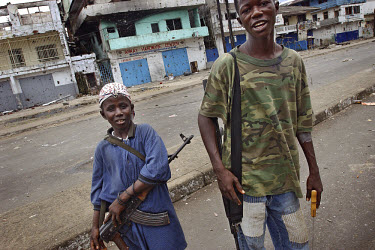 LURD child soldier on Bushrod Island. 'Private Fuck Cat' says he is twelve years old, but is already a veteran of the bloody insurgency in Liberia. "I want to go back to school", he now says. The ong...