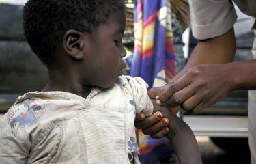 Child being immunised during a visit by a mobile health clinic.