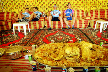 Traditional Qatari feast at the end of a stage for participants in the the Tour de Qatar.  The international cycling circus, invited by the ultra-rich oil state of Qatar, pays its first visit to the M...