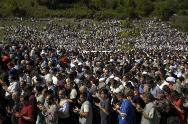 The crowd prays for the victims of the Srebrenica massacre. War Crimes.