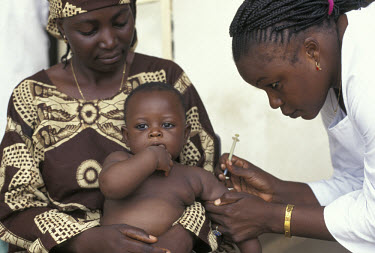 Immunising baby at health clinic.