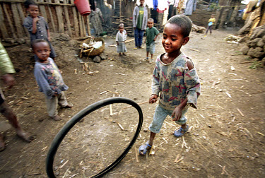 Children playing with an old bicycle tyre in the street of a slum in Bahir Dar, near Lake Tana.