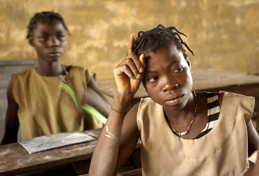 Two girls sit in a school classroom in the village of Koutagba.