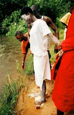 Part of the juju ritual where the girl has to sacrifice a chicken to offer to the god of the river. Thousands of Nigerian women are trafficked into Western Europe every year. They are forced to work i...