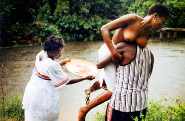 Woman offered to Okun, the river god, in a juju (voodoo) ceremony. Thousands of Nigerian women are trafficked into Western Europe every year. They are forced to work in the sex industry to pay back de...