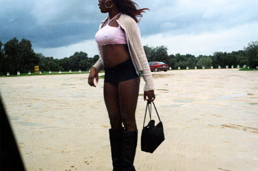 Mary, a Nigerian sex worker, working during the day. When this picture was taken the temperature was only 5 degrees. Thousands of Nigerian women are trafficked into Western Europe every year. They are...
