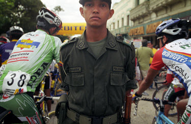 Soldier at the start of a stage in the Vuelta a Colombia. The 53rd Vuelta a Colombia took place against a backdrop of civil war and violence. The bicycle race is guarded along its entire route by heav...