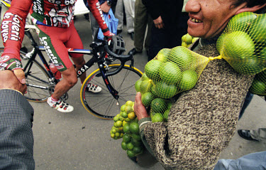 Man selling limes along the route of a stage in the Vuelta a Colombia. The 53rd Vuelta a Colombia took place against a backdrop of civil war and violence. The bicycle race is guarded along its entire...