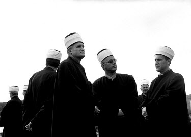 Muslim imams gather at a funeral.