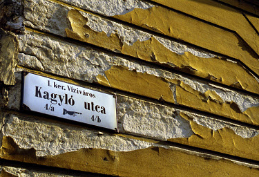 Detail of a wall and street sign in Buda.