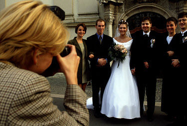 Photographing a wedding group on a Budapest street.